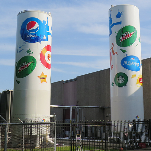 PepsiCo brand logos installed on large outdoor siloes.